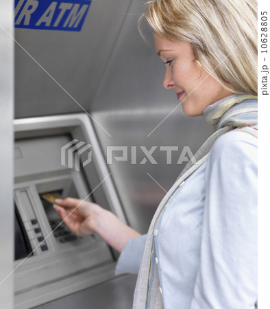 Woman using cash machine Woman using cash machine 10628805