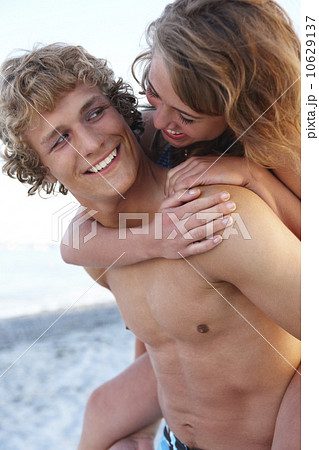 Young man carrying girlfriend on back Young man carrying girlfriend on back 10629137