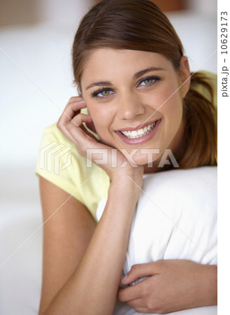 Portrait of young woman lying on bed 10629173
