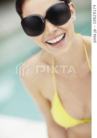 Smiling woman wearing bikini and sunglasses 10629174