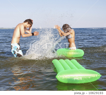Young couple splashing in ocean 10629193