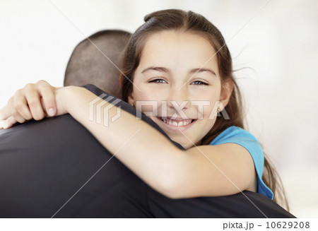 Father coming back from work embracing daughter (10-11) 10629208
