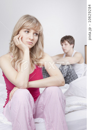 Couple sitting on bed after arguing Couple sitting on bed after arguing 10629284