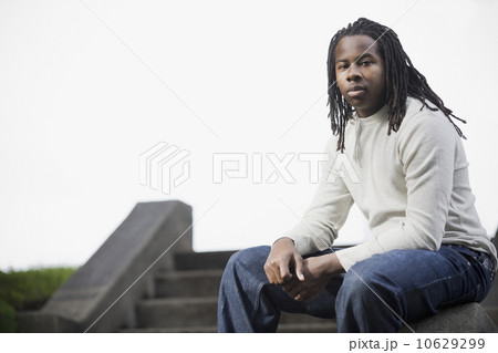 Portrait of teenage boy (16-17) with dreadlocks, sitting on steps Portrait of teenage boy (16-17) with dreadlocks, sitting on steps 10629299