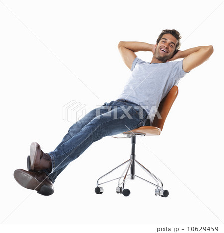 Studio shot of young man relaxing on chair Studio shot of young man relaxing on chair 10629459