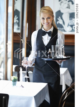 Portrait of young waitress holding tray and wine glasses 10629569