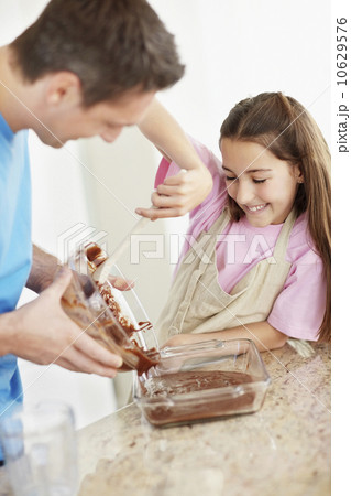 Daughter (10-11) helping father prepare food Daughter (10-11) helping father prepare food 10629576