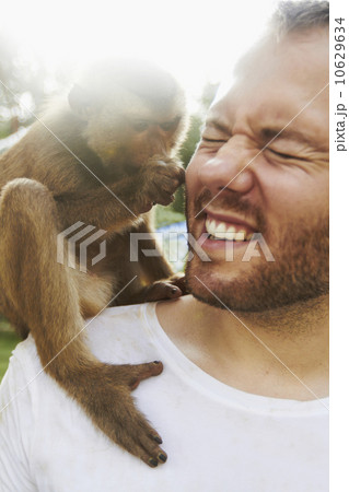 Portrait of man holding monkey 10629634