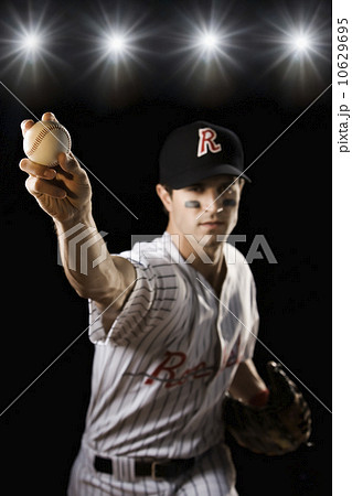 Portrait of pitcher throwing baseball 10629695
