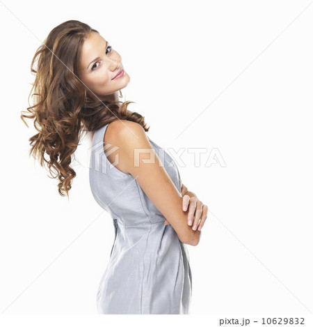 Studio portrait of young attractive woman standing with hands folded 10629832