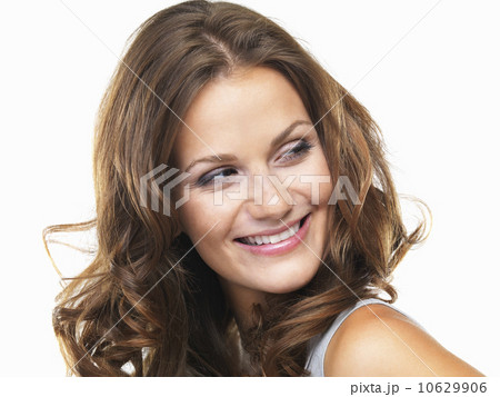 Studio portrait of young woman smiling and looking away Studio portrait of young woman smiling and looking away 10629906