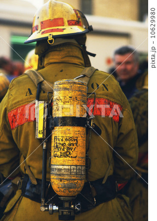 Rear view of fireman wearing oxygen tank Rear view of fireman wearing oxygen tank 10629980