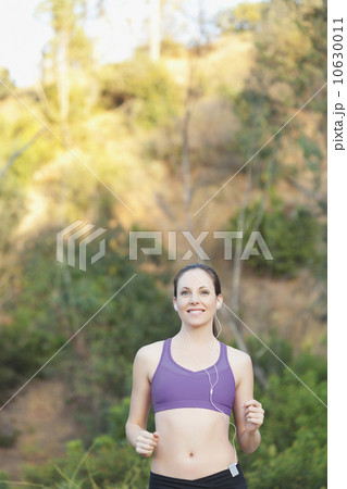 Woman running with headphones on Woman running with headphones on 10630011