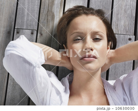 Pretty woman relaxing on porch Pretty woman relaxing on porch 10630030
