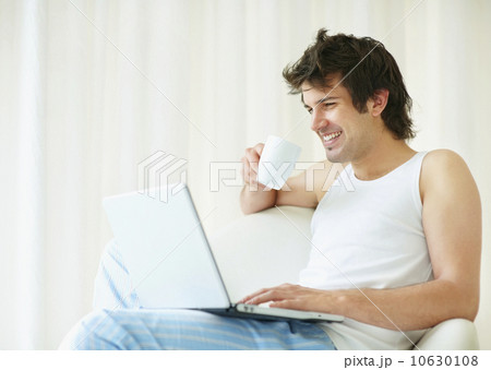 Relaxed man browsing the internet 10630108
