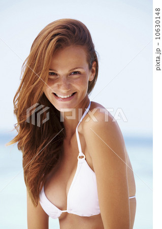 Portrait of smiling young woman in bikini 10630148