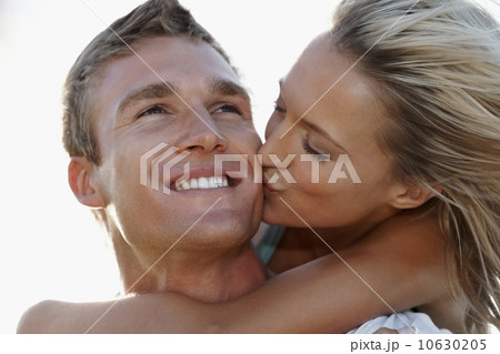 Man giving girlfriend a piggy back ride Man giving girlfriend a piggy back ride 10630205