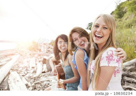 Portrait of young women with guitar on beach Portrait of young women with guitar on beach 10630234