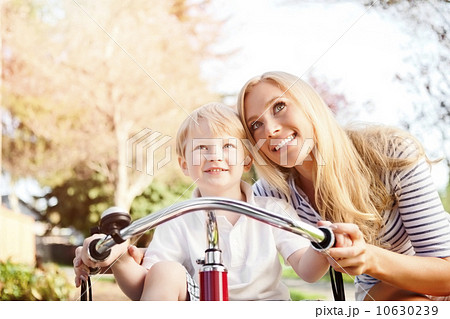 Mother and son (2-3) riding tricycle in park Mother and son (2-3) riding tricycle in park 10630239