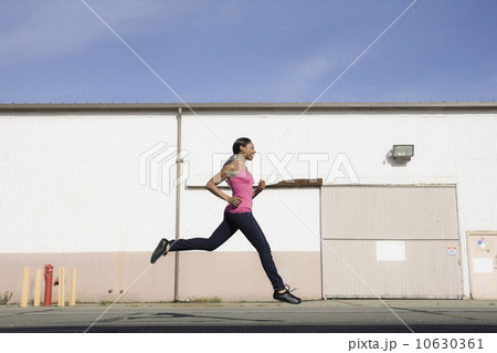 A woman jumping on a road 10630361