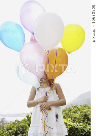 Young girl holding balloons 10630509