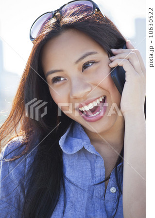 Woman talking on mobile phone outdoors Woman talking on mobile phone outdoors 10630522