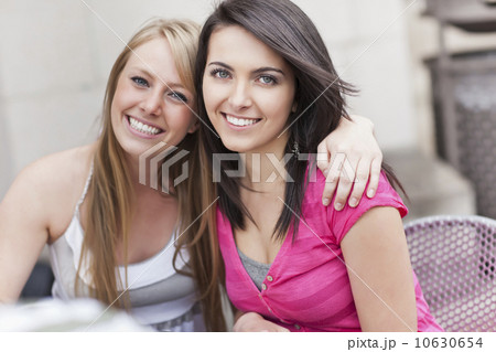 Portrait of two women embracing 10630654