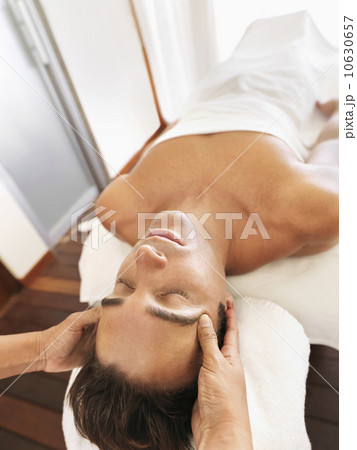 Man getting facial massage in spa 10630657