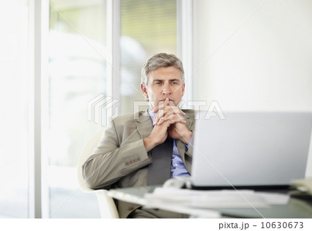 Portrait of contemplative businessman with laptop 10630673