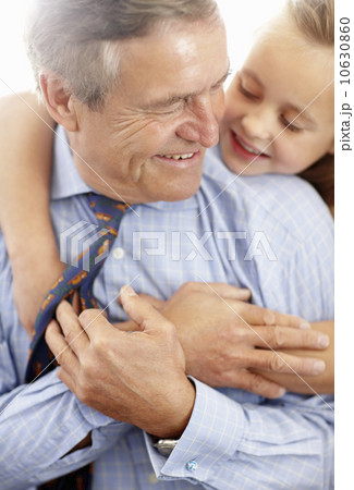 Grandfather and granddaughter (10-11) hugging Grandfather and granddaughter (10-11) hugging 10630860