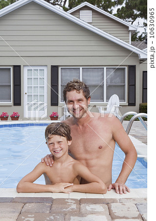 Father and son posing in swimming pool Father and son posing in swimming pool 10630965