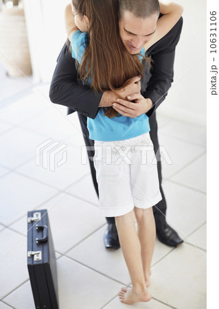 Father coming back from work embracing daughter (10-11) 10631106