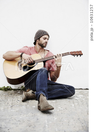 Musician playing guitar outdoors 10631257