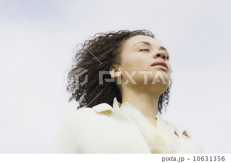 Young woman with eyes closed, outdoors Young woman with eyes closed, outdoors 10631356
