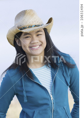 Portrait of teenage girl wearing cowboy hat Portrait of teenage girl wearing cowboy hat 10631494