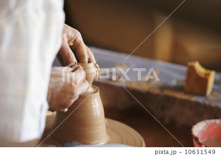 Hands working with clay on potter's wheel Hands working with clay on potter's wheel 10631549