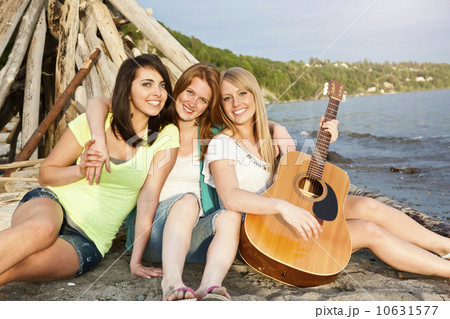 Portrait of three young women hanging out on beach Portrait of three young women hanging out on beach 10631577