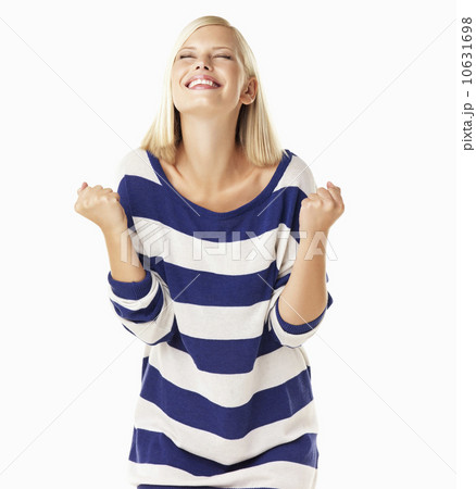 Studio portrait of young woman clenching fists Studio portrait of young woman clenching fists 10631698