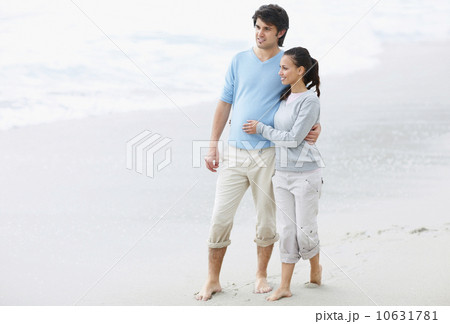 Couple walking barefoot on the beach Couple walking barefoot on the beach 10631781