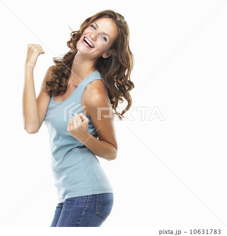 Studio portrait of attractive young woman celebrating success Studio portrait of attractive young woman celebrating success 10631783