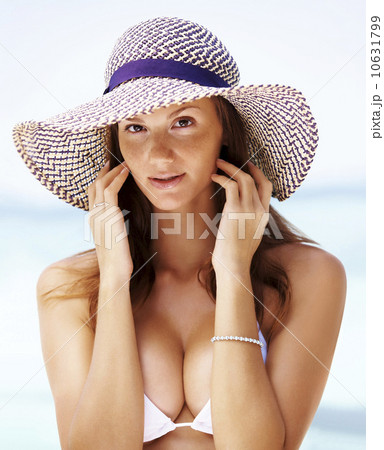 Beach portrait of young woman wearing white bikini 10631799