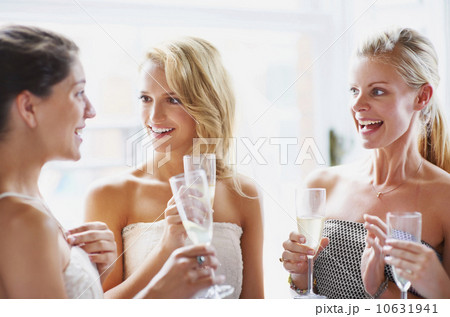 Bride and bridesmaids toasting and talking 10631941