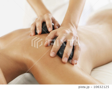 Woman relaxing while getting stone massage 10632125