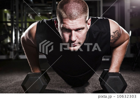 Mid adult man working out in gym Mid adult man working out in gym 10632303
