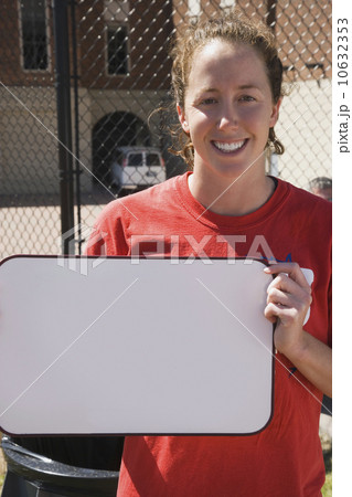 Teenage girl holding blank whiteboard 10632353