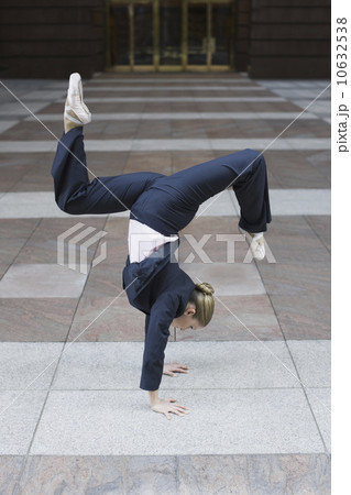 Businesswoman dancing in urban setting 10632538