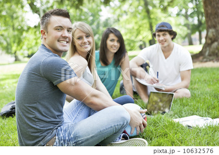 Portrait of college students relaxing on grass 10632576