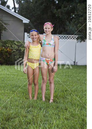 Girls posing on lawn 10632720