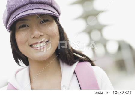 Portrait of young woman smiling, outdoors 10632824