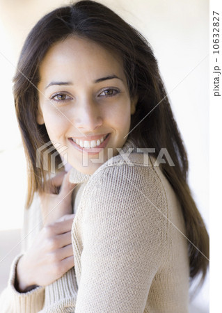 A woman smiling and huggin arms to chest A woman smiling and huggin arms to chest 10632827